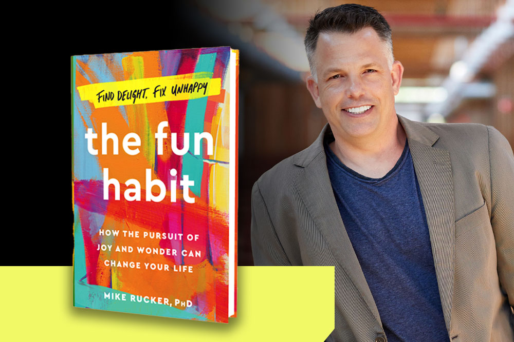 A smiling man stands against a blurred background. Next to him is the cover of a colorful book titled "The Fun Habit: How the Pursuit of Joy and Wonder Can Change Your Life" by Mike Rucker, PhD. The book's subtitle reads, "Find Delight, Fix Unhappy," promoting healthy habits along the way.